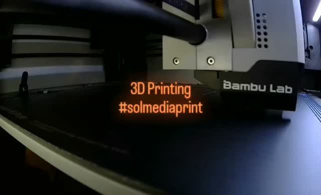 Blue dimensional letter being printed on a Bambu Lab 3D printer
