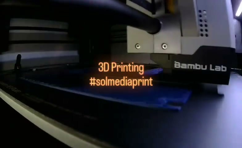 Blue channel-letter component being formed inside a Bambu Lab 3D printer