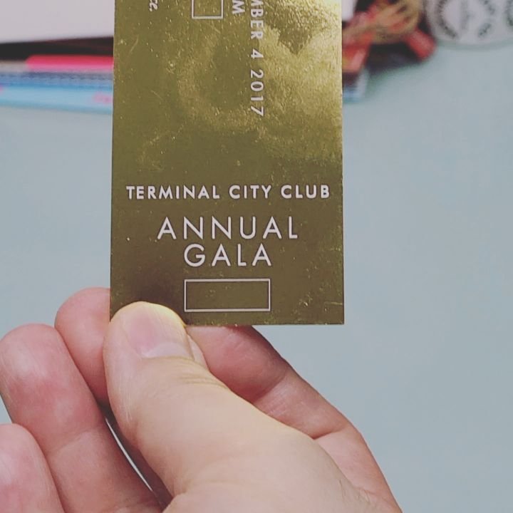 Gold foil gala card held in hand