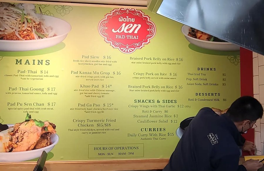 A large restaurant wall graphic being installed on site